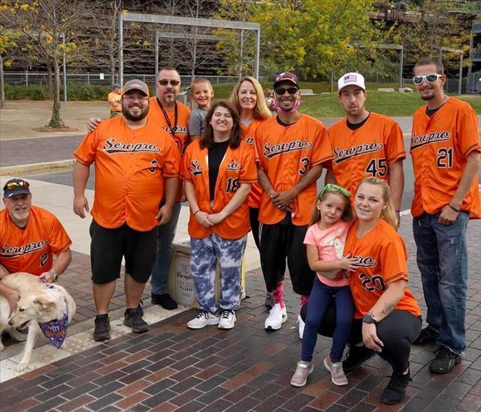 group of people in orange jerseys