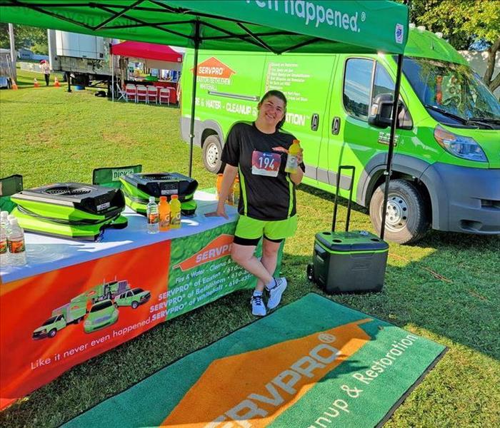 girl standing in front of tent holding gatorade