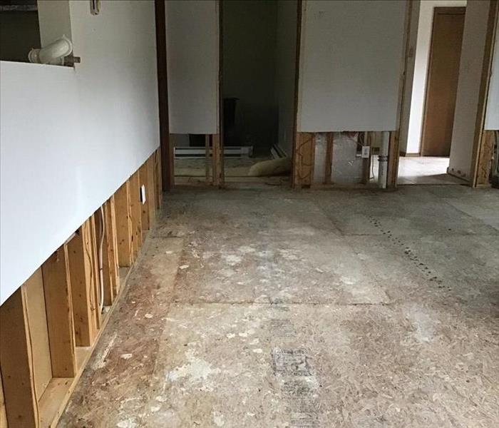 Flood cuts and removed flooring in a living room.