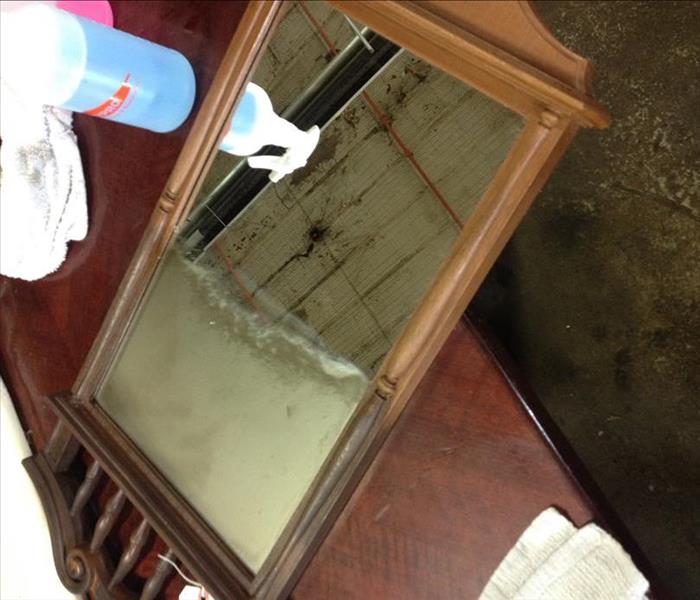 Demonstration of before and after cleaning a smoke damaged mirror