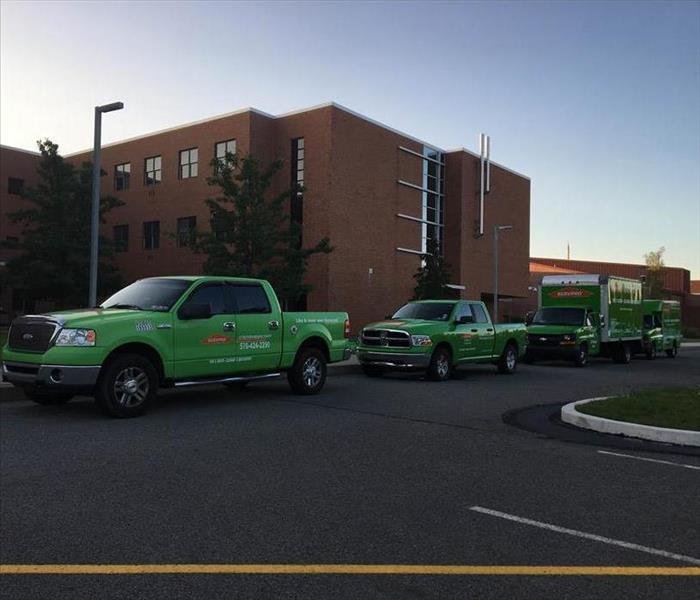 SERVPRO trucks parked outside property.