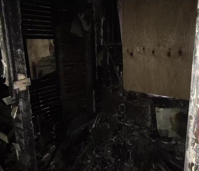 Severe fire damage inside a home, everything seems burnt